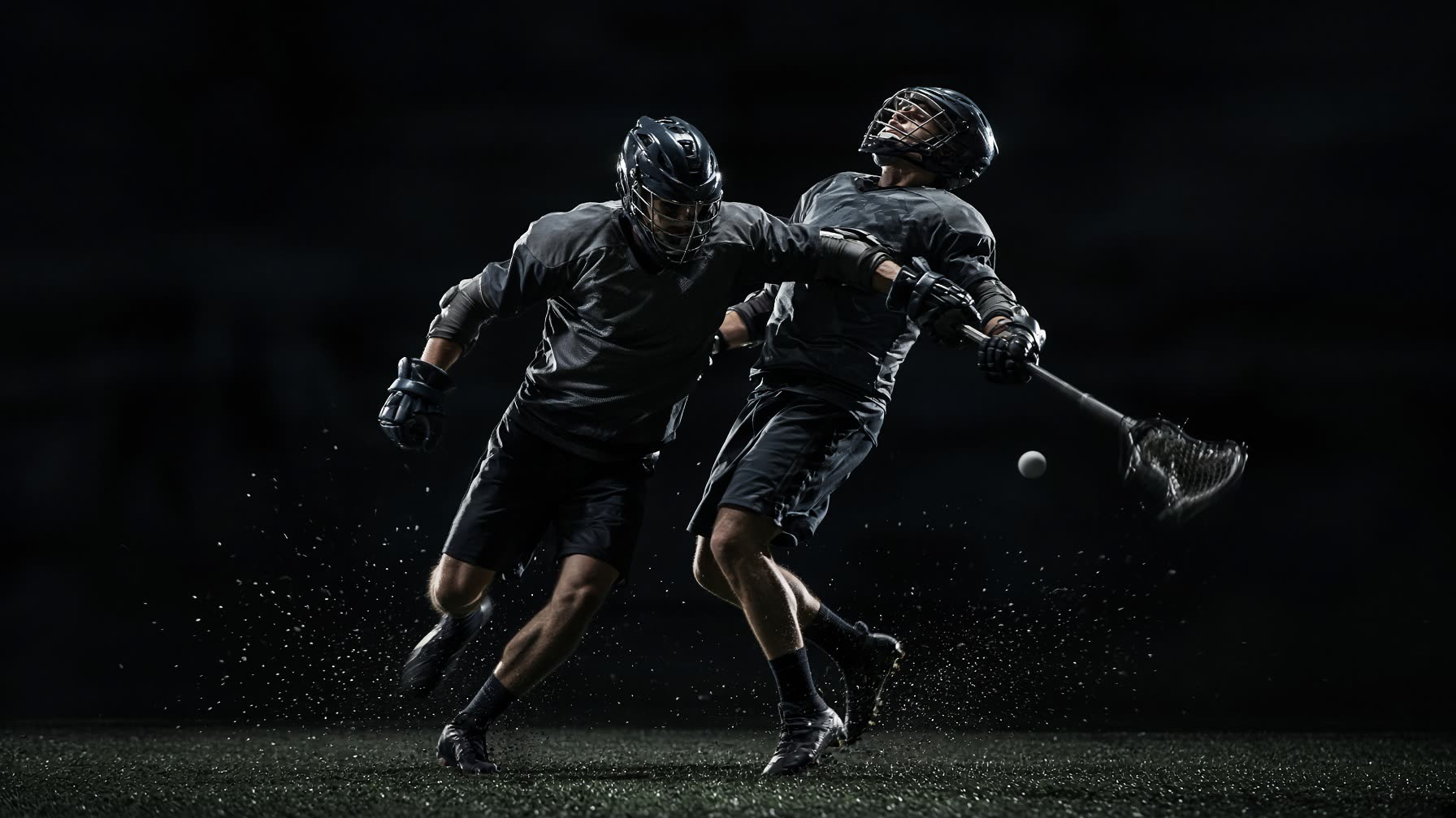 Two lacrosse players collide chasing a loose ball.